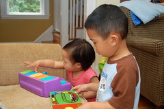 Owen and Aki playing with Logan's toys