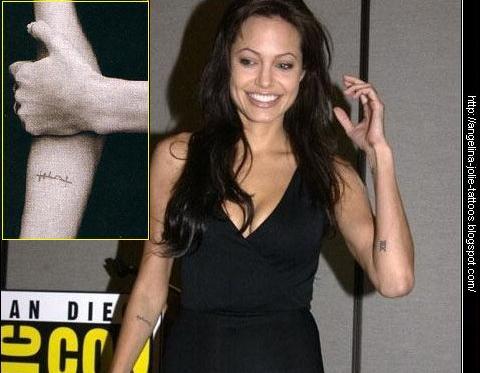 Angelina Jolie tattoos. Arabic phrase "???????" (strength of will) This is