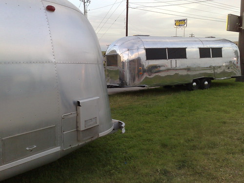 vintage Airstream Overlander 1966 and on the right a 1950s one fully polished - now THATs what we need for our sno-mobile!