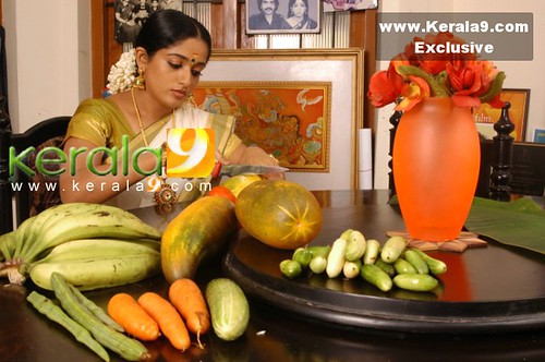 Kavya with moringa, cucumbers, bananas, carrots, etc.