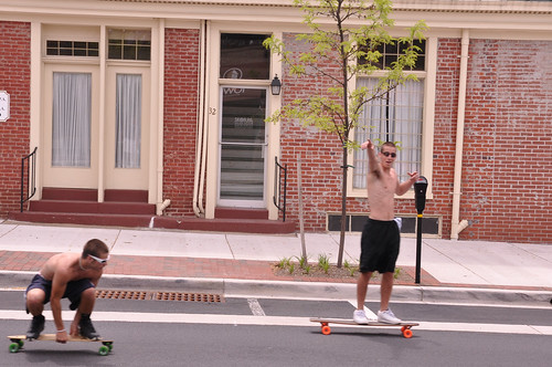 Teenagers skate down Main Street in Bel Air, MD.