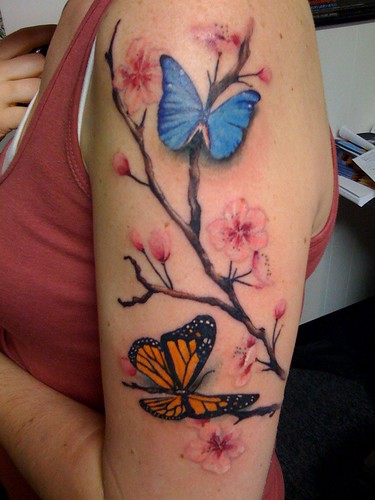 monarch butterfly tattoo. blossoms and utterflies