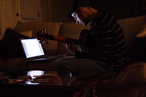 jon practicing guitar by computer-light