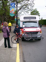 Transit operator demoing how to load bike
