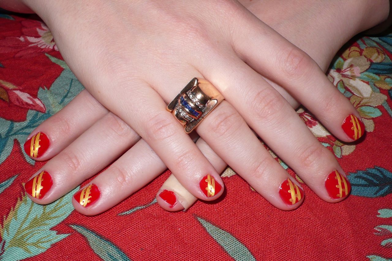 Nail design in Diagonal Golden Lines on Red Background