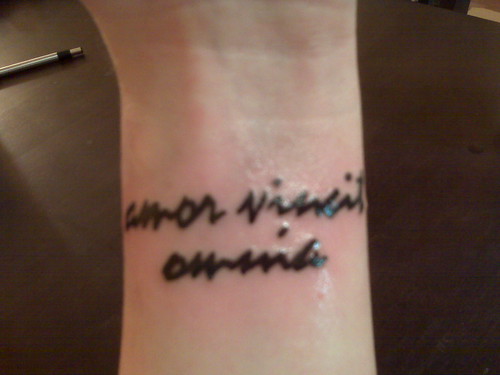 Left wrist tattoo. It says "amor vincit omnia" which is latin for "love 