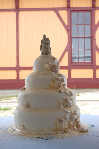  a seashell cake that resembled a sand castle for this beach wedding