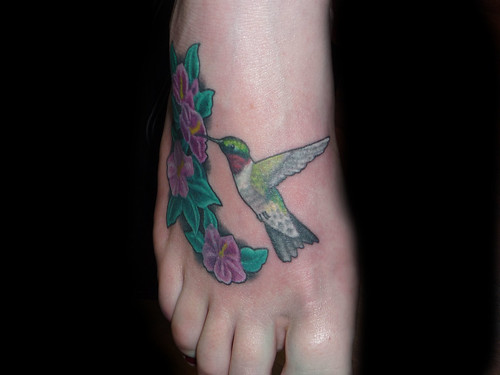humingbird flower tattoo on foot This hummingbird and