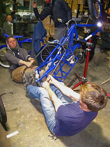 Leif and Emily stretching the Mundo frame to fit electric rear wheel.