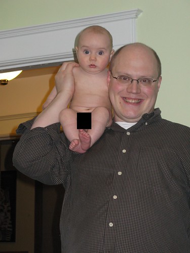 Max as a naked monkey on his dad's shoulder