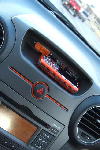 orange car driving phone cellphone rental kia 2009 rondo sooc kiarondo