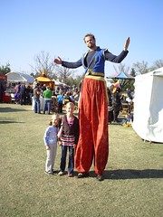 The girls with a man on stilts