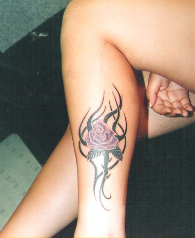 lovely rose tribal tatttoo on lower leg by dublin ireland tattoo artist 