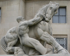 This sculpture, one of a pair found outside of the Federal Trade Commission Building, is entitled "Man Controlling Trade" and was completed for the FTC Building in 1942 by New York sculptor Michael Lantz. 