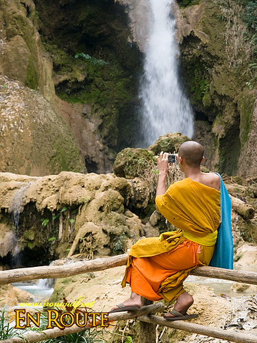 A monk shooting the falls at Laos