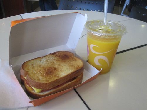 egg and bacon sandwich, orange juice at airport café - $11.25