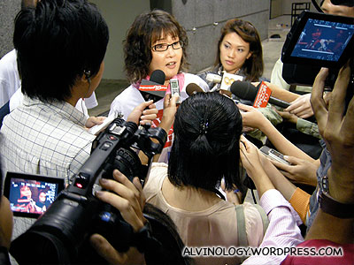 The new AWARE president, Ms Dana Lam, bombarded by the media