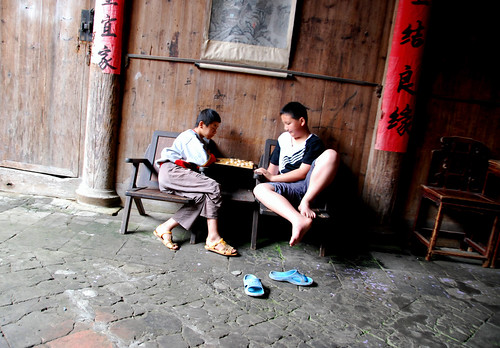 two boys playing chinese chess, xiamei village