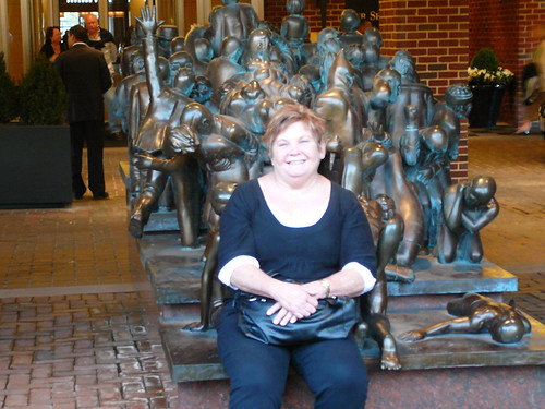 Auntie Sue waits for the hop on hop off bus using the statue as a seat