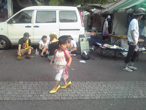 Little girl wearing mom's shoes