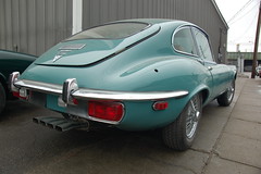 Old Jaguar E-type sports car: back fender & ex...