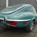 Old Jaguar E-type sports car: back fender & ex...