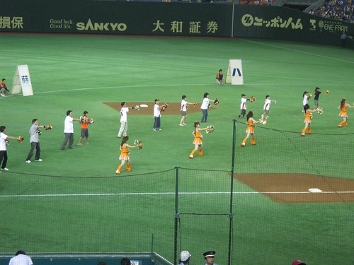 The cheerleaders and the fans doing their routine.