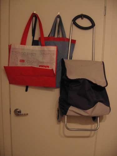 Bag and basket station on hooks behind the door