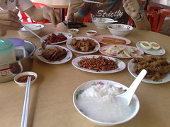 Three bosses having an early New Year's Day Eve lunch of Teochew porridge