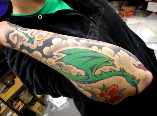 Molly's Dragon in Clouds Tattoo Molly's dragon is gorgeous 