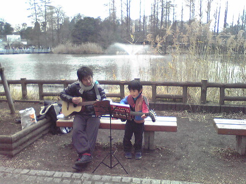 Young musician performing Beatles song with his dad at Inokashira Park