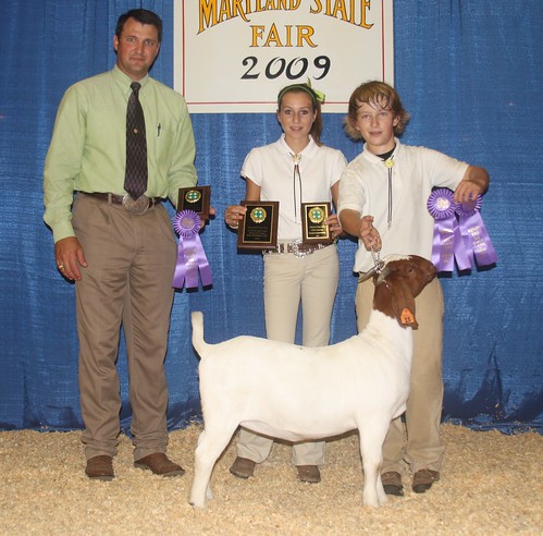 Grand Champion Doe and Best Bred and Owned Breeding Goat exhibited by Cooper Bounds (R)