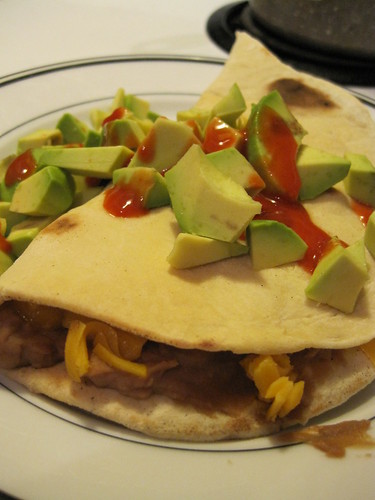 Homemade Tortillas with refried beans, cheese, avacado, and hot sauce