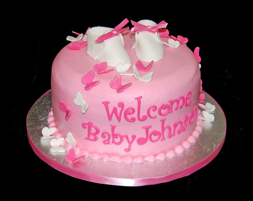 pink butterfly baby shower cake with baby booties