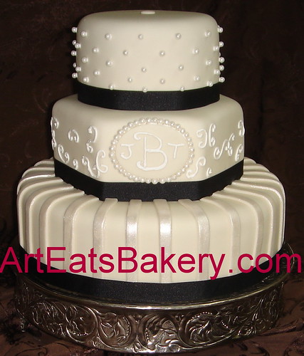 Three tier fondant wedding cake with black ribbons