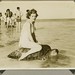 Young woman riding on the back of a turtle at Mon Repos Beach by State Library of Queensland, Australia