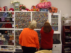 Owner Janet assisting a customer match buttons to a project