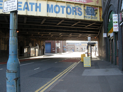 Shops and bus stops under the railway lines