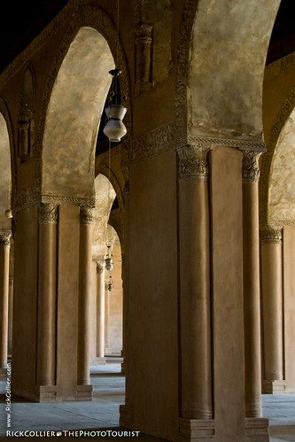 Lamps hang in the arches of the prayer arcades at ibn Tulun mosque in Cairo, Egypt.