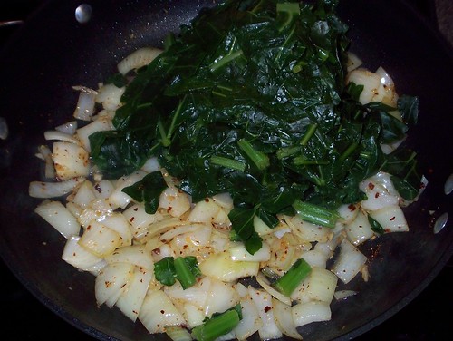 adding cooked collards to onions