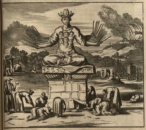 many-armed deity atop pedestal