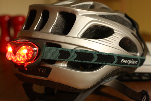 Red LED headlamp on bike helmet