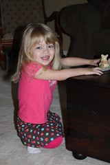 playing with a pig figurine