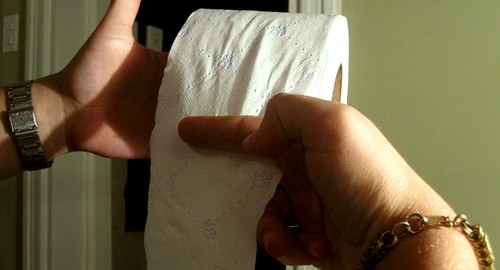 mano cortando el papel higienico haciendo el gesto de las tijeras con los dedos