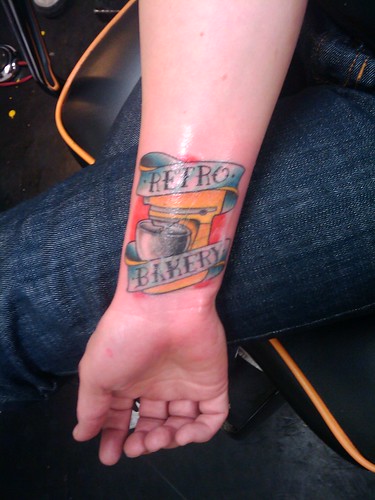  Kari Haskell loves her bakery, she got the logo tattooed on her arm!