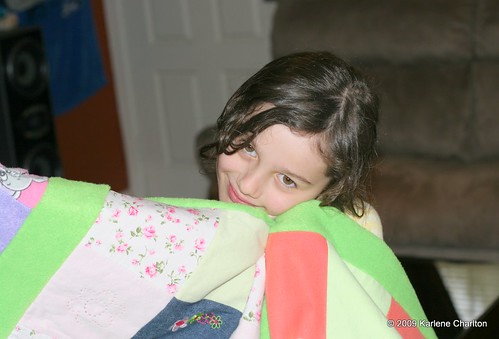 Rylee cuddles her new quilt