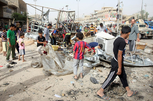 Children at the scene of a bombing in Sadr City, Iraq on May 23, 2011. The war inside Iraq has escalated since the beginning of the year. by Pan-African News Wire File Photos
