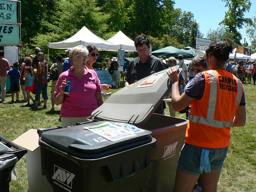 A Green Team volunteer helps festival attendees sort at the 2010 festival.