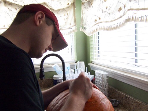 Brandon carving a pumpkin