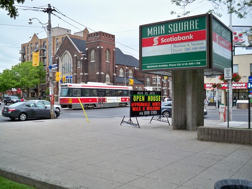The corner of Main and Danforth, viewed from within Main Square. This intersection is a TTC hub, with various bus routes, and the Main St. subway station just a few steps up Main St. 